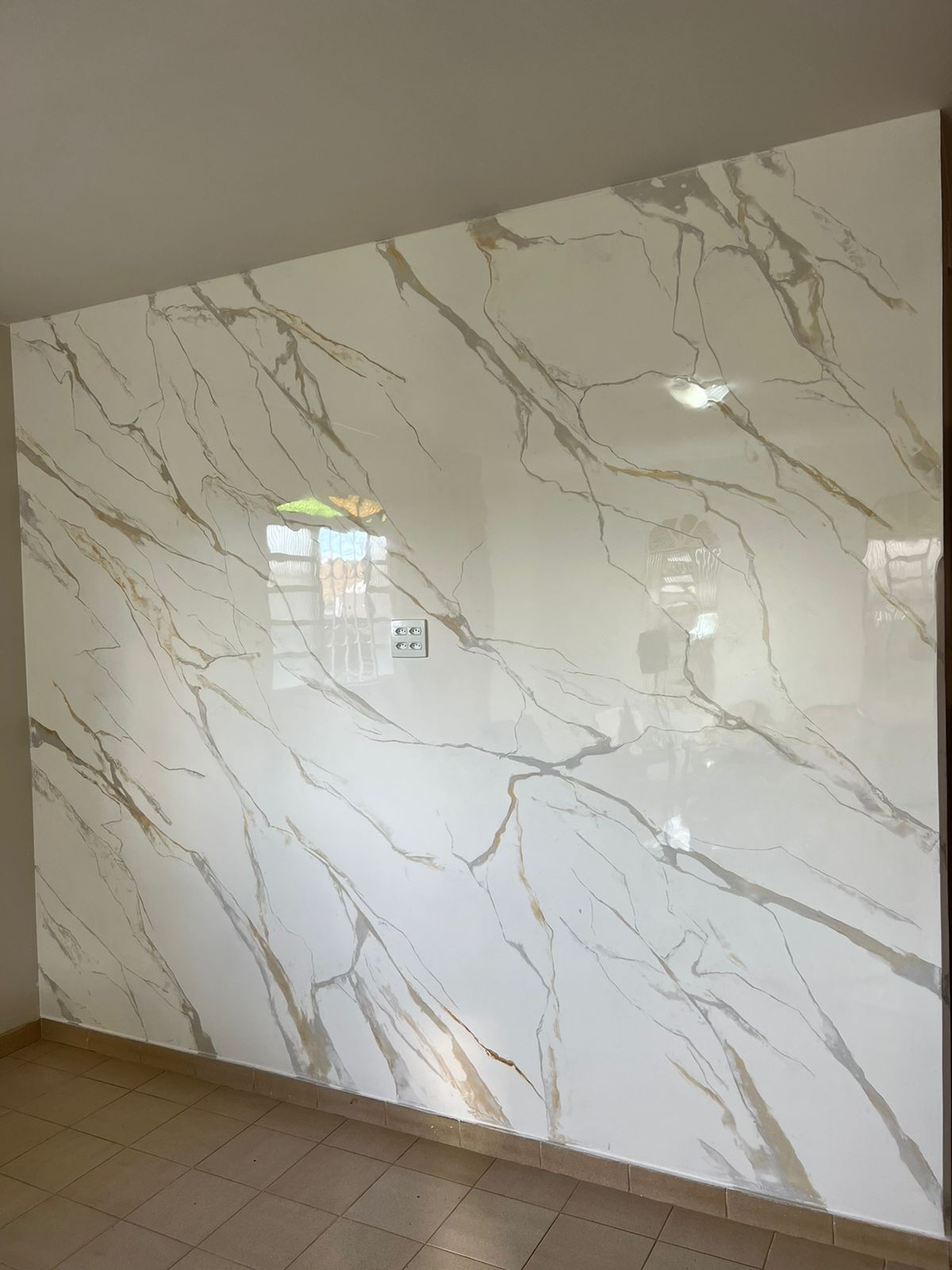 Calacatta white marble effect feature wall with champagne gold veining